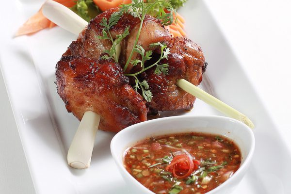 Grilled marinated chicken thigh with crunchy vegetables and spicy e-sarn sauce