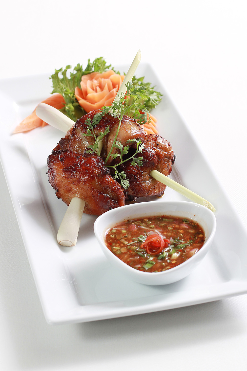 Grilled marinated chicken thigh with crunchy vegetables and spicy e-sarn sauce