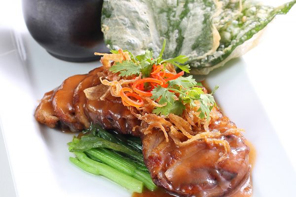 Grilled smoked duck breast with crispy battered wild betel leafs and tamarind sauce drizzled